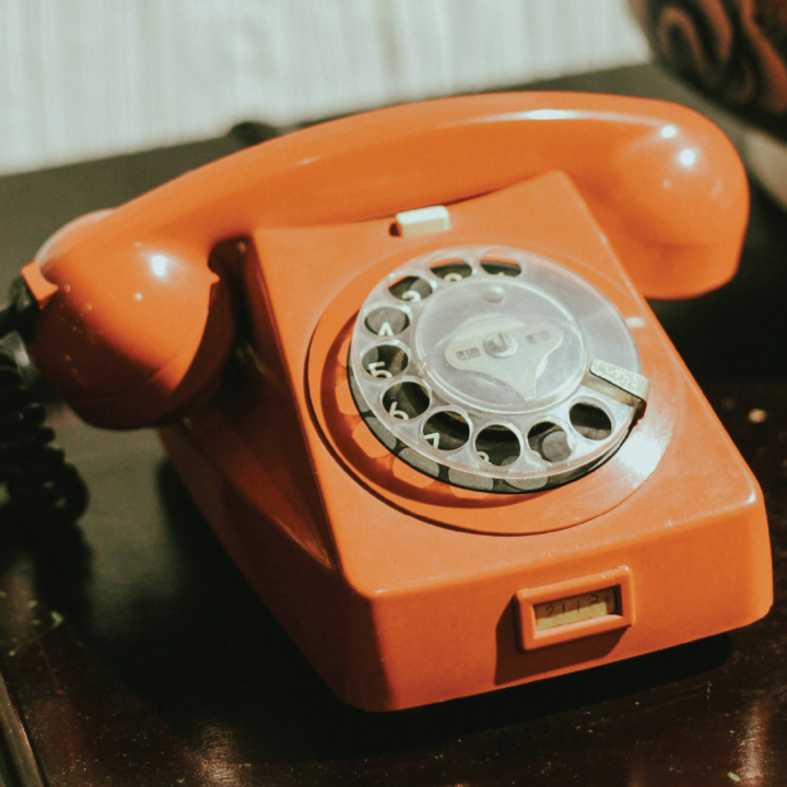 An orange retro telephone.