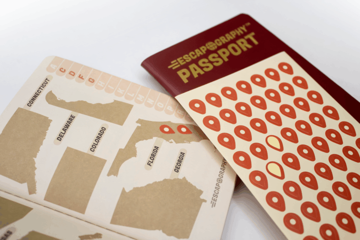Pin stickers shown being used on the map pages of the passport.